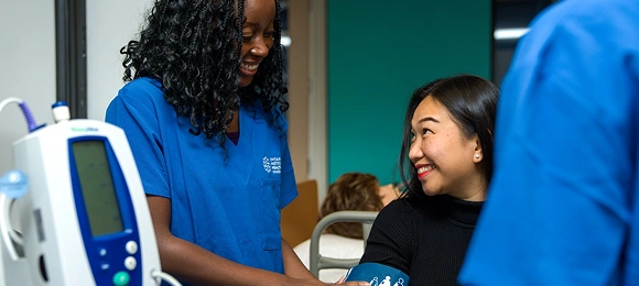 An OIHI student taking a patient's vitals